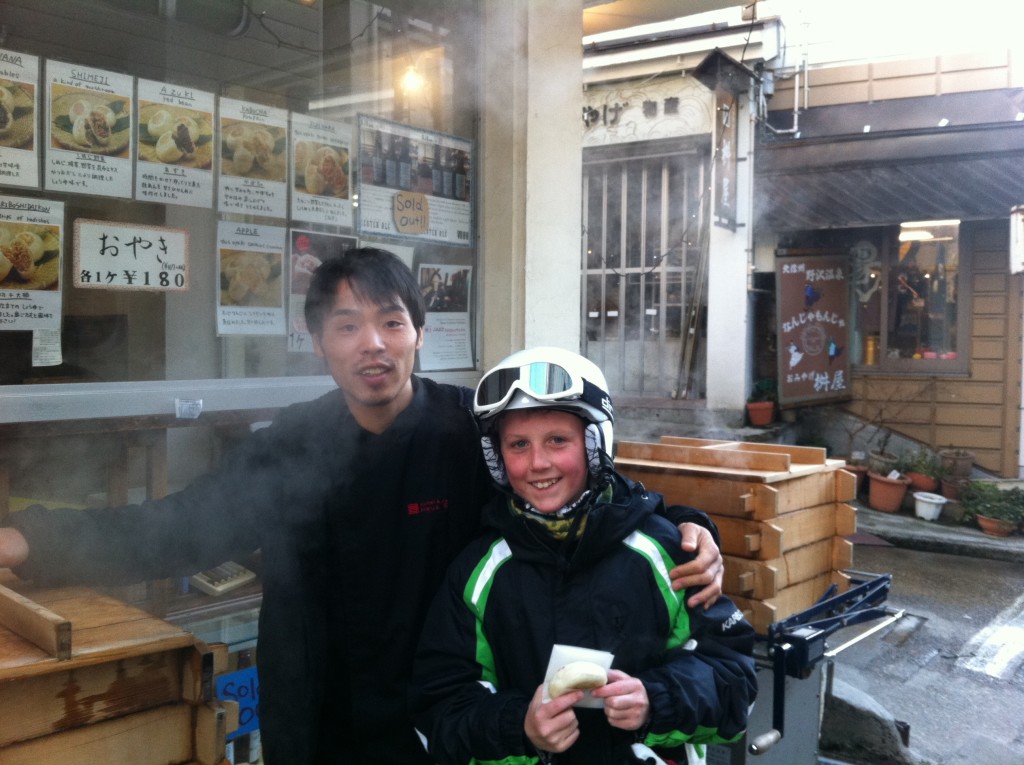Mitchell buying oyaki in the main street of Nozawa Onsen